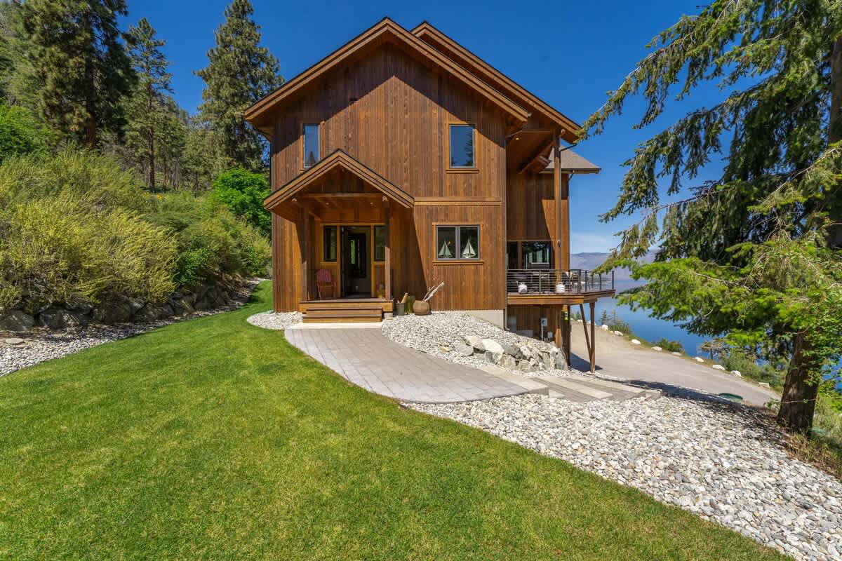 Exterior / Entry of home with well-maintained grassy yard