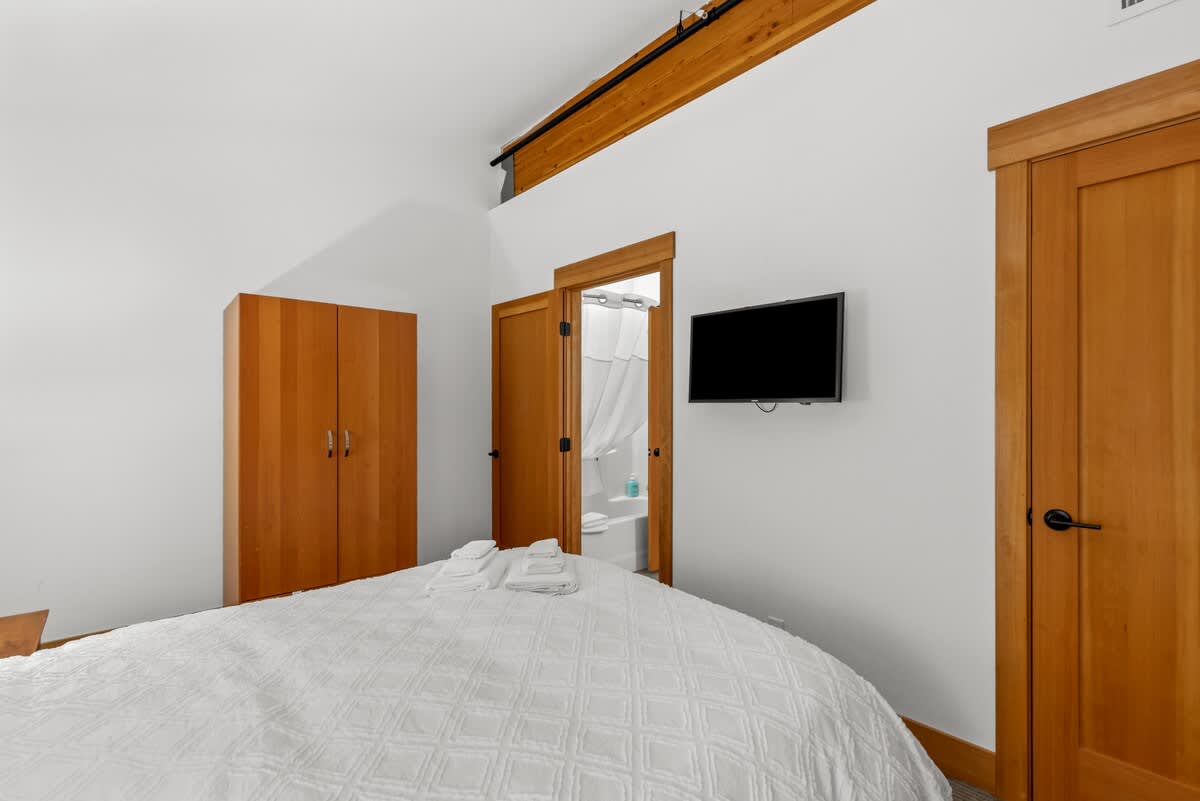 Bedroom has Queen Sized Bed and TV.